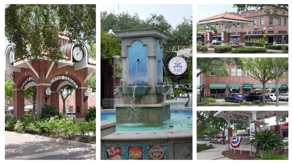 Brick archway entrance with clocks and greenery in a town square area.